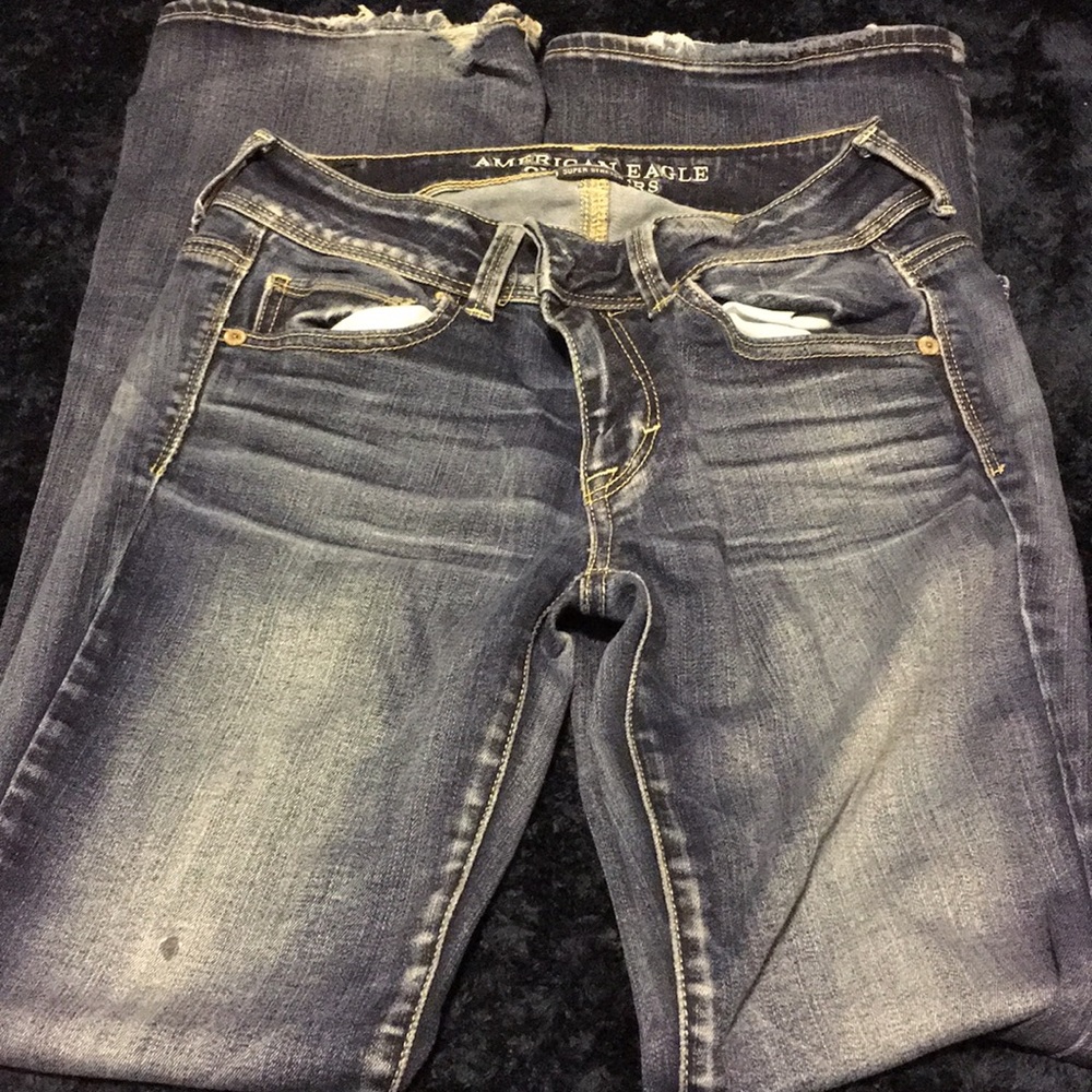 Dark-wash boot cut jeans.